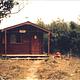 Koknuk cabin photo taken in 1987 showing wood cabin and trail leading to it