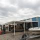 Front of the main marina/maintenance building with boats and equipment visible — supports marina services, storage and boatyard facilities described on the site.