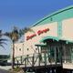 Front exterior of the Sugar Barge building with entrance ramp and signage — shows the waterfront bar & grill facility on the property (used as site header image).