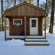 Small wooden cabin in snow—shows the campground’s cabin lodging option and seasonal conditions; sourced from the campground’s photo gallery.
