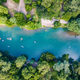 Aerial view of the on-site lake and surrounding tree cover with people floating — supports property waterfront scenery; file originates from the resort site (page shows canyon lake imagery).