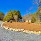 Gravel RV pad with an Airstream trailer and landscaped rock bed — view of actual campsite on the property (from Area Attractions page / site gallery context). Clear, useful for showing RV accommodations.