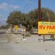 Clear photo of the campground entrance sign reading “Silver Sands RV Park” with trees and site road visible — useful to identify the property and appears on the campground listing page.