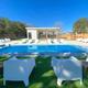 Clear photo of the on-site swimming pool area with lounge chairs, fencing and a pool house — shows guest amenity and layout (page context: Photo Gallery pool image).