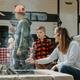 Family roasting marshmallows around a stone firepit in a campsite — highlights amenities (firepit) and guest experience on-site.