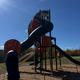 Photograph of an on-site playground structure with trees and open grounds visible — useful to show kid-friendly facilities available at the resort (found in the site’s gallery/promotional posts).