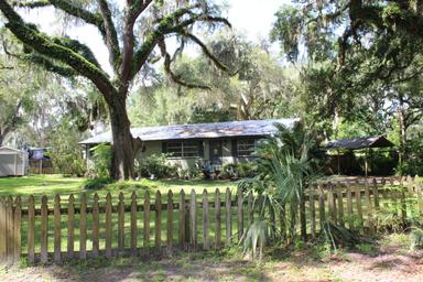 Boat slips beneath live oak trees at Lake Rousseau