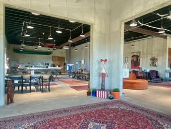 Interior shot of the Venga communal/lounge space showing layout, decor and guest seating — good for highlighting on-site common areas and atmosphere.
