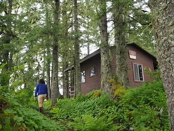 Person walking up to Gut Island 1 Cabin