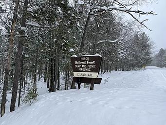 A snowy photo of Island lake (MI) sign 