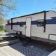 RV parked at a marked campsite with picnic table and pad — useful view of an RV site and site setup for guests.