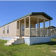 Another angled exterior of several cabins in a line with porches and open grounds — provides additional perspective on cabin arrangement and property character (image from site media).