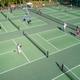 Overhead view of multiple pickleball courts with players — represents the resort’s on-site sports facilities (site advertises numerous pickleball courts).
