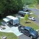 Aerial shot of paved RV sites with concrete pads, fire rings and picnic tables — clearly depicts RV pitch layout and amenities featured on the campground site.