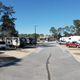 Ground-level view down the main RV lane showing pulls/parking pads and RVs on both sides — suitable for depicting campsite layout (from the gallery screenshots page).