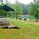 Picnic shelter, grills, and picnic tables beside the lake/pier — useful for showing on-site picnic and waterfront amenity areas (matches page context for resort facilities).