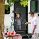 Shows an RV entry and a campsite picnic setup with a family member at the door — useful for illustrating RV accommodations and family use of sites (sourced from the property’s 'ways to stay' photos).