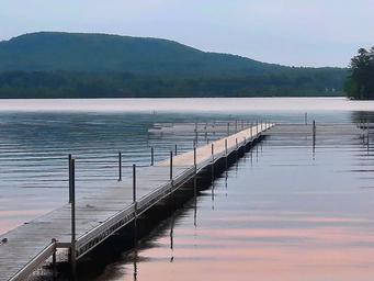 Long dock stretching into calm lake waters — highlights the campground’s waterfront access and dock facilities; image appears on the campground’s Map page.
