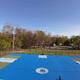 Aerial/overview-style image of a multi-sport court (pickleball) with surrounding campground in the background; appears in amenities/gallery content for the resort.