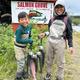 Inflatable boat full of fish and anglers with the camp mentioned in the adjacent text — supports the property’s self-guided fishing and boat transport services noted on the website.