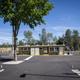 Clear daytime photo of the park’s central building/office and surrounding paved RV sites — matches site gallery page (photo-gallery) and shows layout and infrastructure.