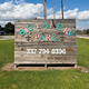 Close-up of the wooden Big Lake RV Park entrance sign with phone number — identifies property and is appropriate for a gallery cover or contact visual.