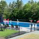 Outdoor swimming pool with lounge chairs and fenced area — shows an on-site amenity (matches pool photos on the site).