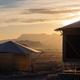 Exterior of luxury safari tents with sunrise views of the Chisos Mountains at Camp Elena in Terlingua, Texas, near Big Bend National Park.