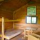 Gut Island Cabin 2 interior with wood table and wooden bunkbeds