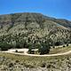 Overview of Dog Canyon campground and loop road with view of mountains in the background.
