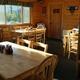 Interior photo of a wood-paneled dining area with tables and service area — matches site text about a full-service restaurant/café on the property and shows guest amenities.