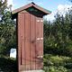 Outhouse at Koknuk Cabin surrounded by vegetation with green plexiglass as roof