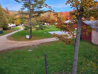 Elevated/near-overhead perspective of the campground showing road loop, multiple sites and surrounding trees — useful overview of the property layout. (Image appears on the campground homepage.)