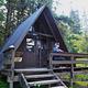 Person looking at scenery from railing of Mount Rynda Cabin exterior A Frame cabin