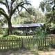 Boat slips beneath live oak trees at Lake Rousseau