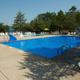 Large outdoor swimming pool with deck chairs and umbrellas — prominent facility shown on the Arrowhead RV Resort page and suitable for the property gallery (banner-style photo on the listing).