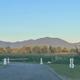 Gated entrance to Riverside Camping & RV Resort with mountains at dusk