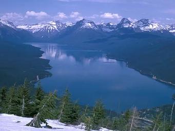 Lake McDonald surrounded by snow covered peaks.