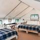 Interior view of a furnished glamping tent showing bed layout and finishes — useful to illustrate accommodations and tent interiors (labeled tent interior on site).