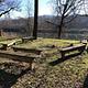 Wooden benches form a horseshoe at the campground's gathering area