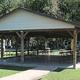 Covered pavilion with picnic tables and adjacent playground area — corresponds to the site’s facilities description (pavilion, bathhouses, and central gathering area).