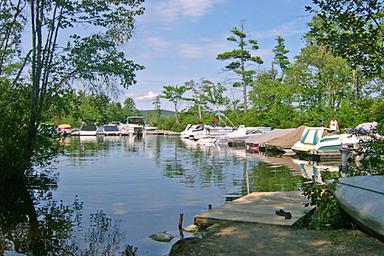 Waterfront view with docks and moored boats — depicts the campground's marina and lake access as shown on the property's homepage gallery.