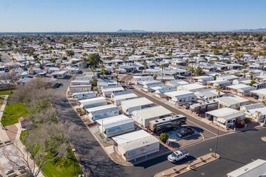 Aerial photograph focused on residential/RV rows and streets within the park, showing lot layout and nearby green space — useful for illustrating campground RV pitches (file labelled ‘Southern-Aerial-13’).