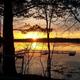 Sunset lake view with dock and shoreline trees — clear scenic shot of Lake George taken from the campsite (used on the property homepage slideshow). Good for showcasing waterfront scenery.
