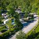 Aerial/drone overview of the campground showing road layout, RVs, trees and site spacing — good for overall property context (matches site background hero showing campground layout).