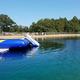 Ground-level image of the pond/pool with an inflatable—shows on-site recreational water amenity and fencing, useful for guest-facing gallery (source: Seasonal Site Information).