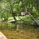 Yellow kayak on river with trees in the background