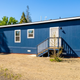 Clear exterior view of a manufactured/mobile home sited on lot grounds — good representation of home styles and lot surface at Sherwood Forest (page listing for Lot 53).