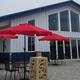 Photo of clubhouse exterior patio with tables, umbrellas and a fire pit — depicts on-site amenities and relaxation area (page references clubhouse/clubhouse waterfall).