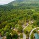 Aerial image showing the resort grounds, pond, pool, building and nearby RV sites — useful to show amenities and site context; sourced from the property page.